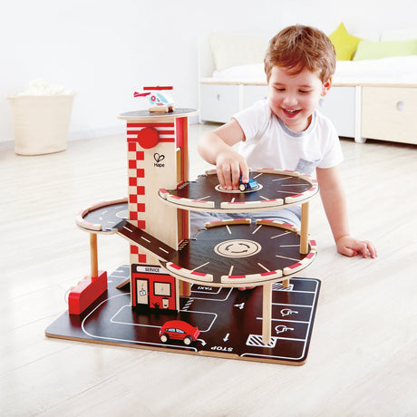 Hape Park Go Garage - Parking pour jouets avec ascenseur, hélicoptère et voitures, 3 ans+