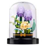 Blocs de construction de fleurs dans une cloche en verre